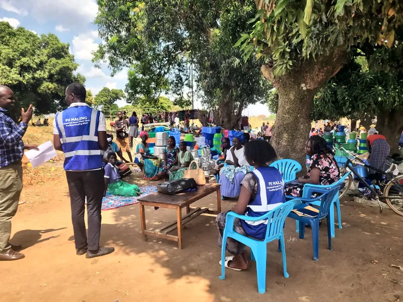 A community meeting under a tree in Gulu, February 2026