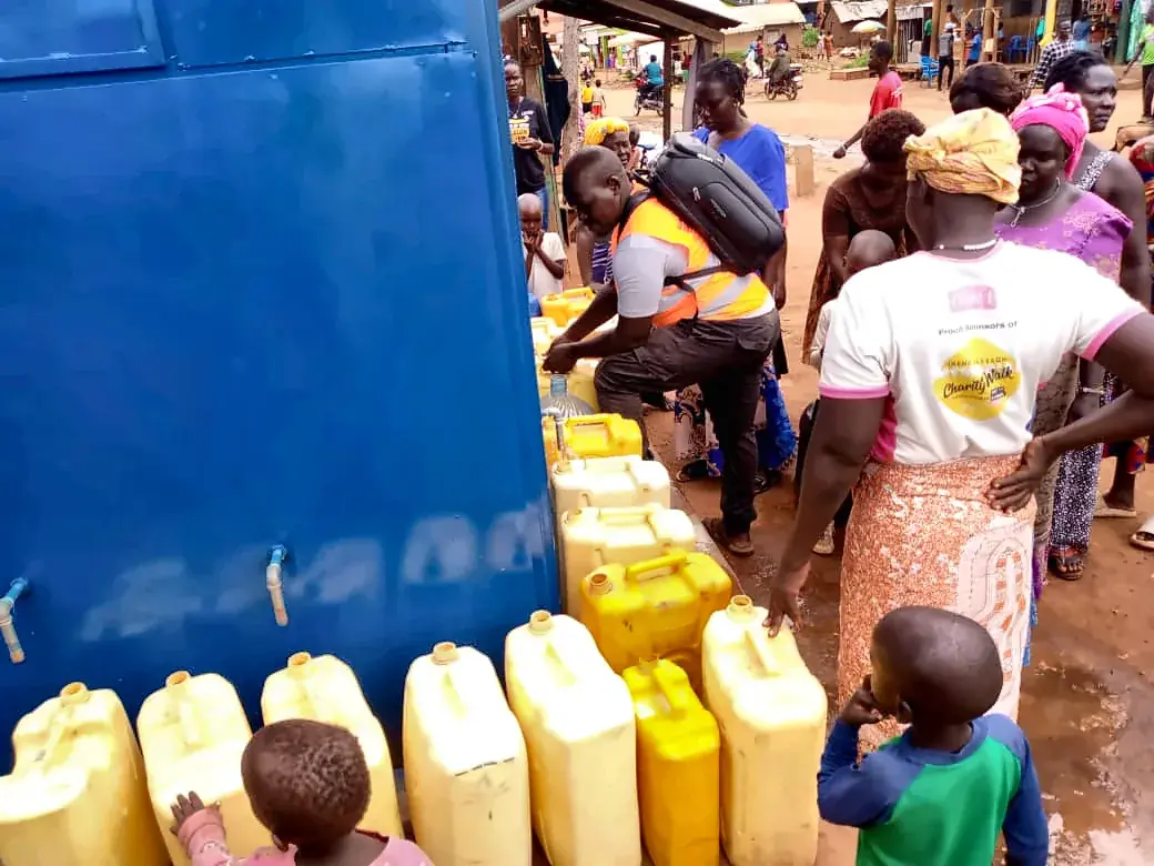 Jerrycans lined up at the taps of a busy Pii-Maleng kiosk