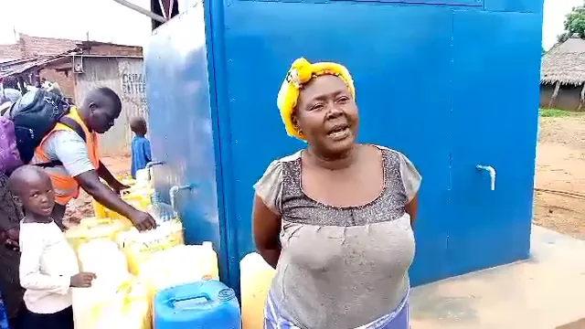 A Local Council I leader speaking at a Pii-Maleng kiosk